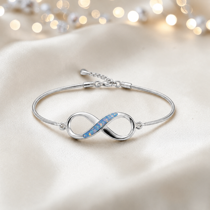 Infinity Bracelet — silver infinity ashes memorial bracelet, in baby blue, handcrafted in Lancashire, UK - by Keepsake Memorial Jewellery
