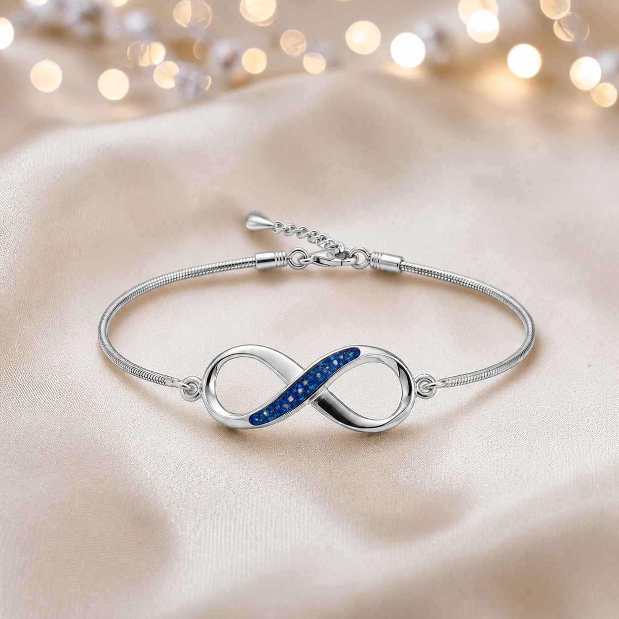 Infinity Bracelet — silver infinity ashes memorial bracelet,  in sapphire glow, handcrafted in Lancashire, UK - by Keepsake Memorial Jewellery