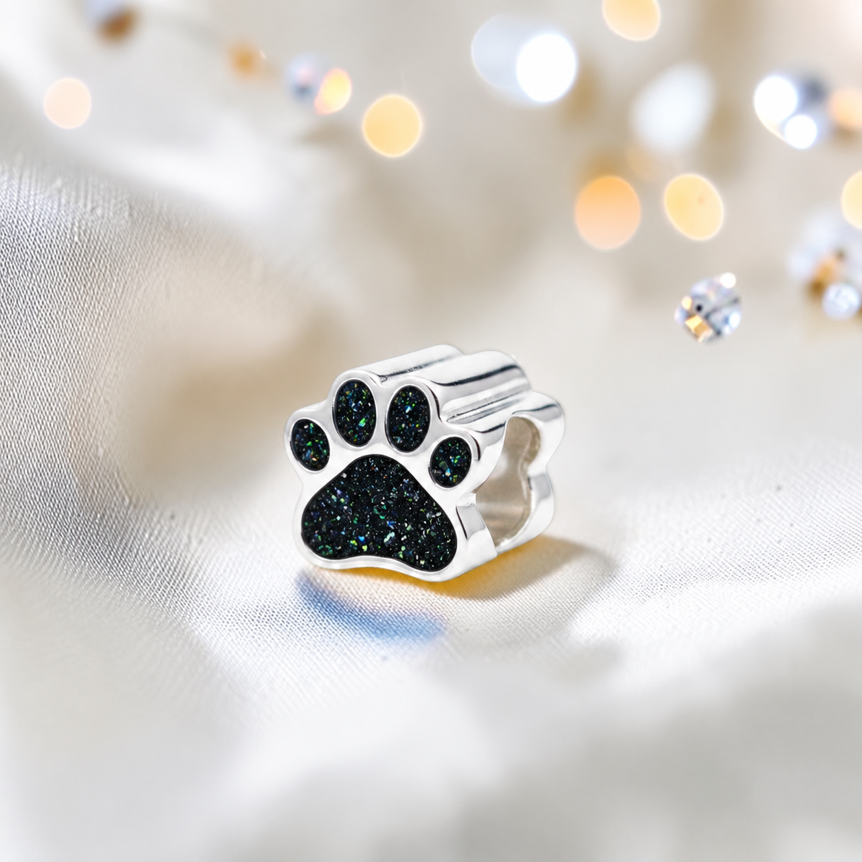 Lily paw silver ashes charm, in black flame, handcrafted in Lancashire UK - by Keepsake Memorial Jewellery 