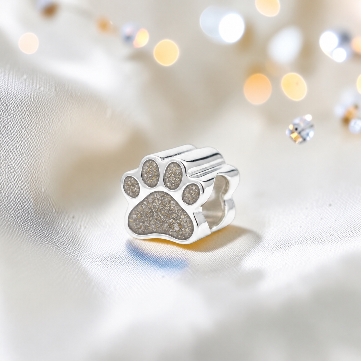 Lily paw silver ashes charm, in natural ash, handcrafted in Lancashire UK - by Keepsake Memorial Jewellery 