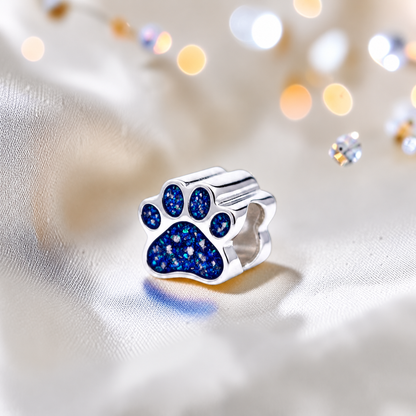Lily paw silver ashes charm, in sapphire glow, handcrafted in Lancashire UK - by Keepsake Memorial Jewellery 