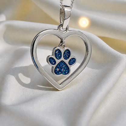 Lily pendant - heart shaped memorial ashes pendant with central paw charm in sapphire glow, handcrafted in Lancashire UK - by Keepsake Memorial Jewellery