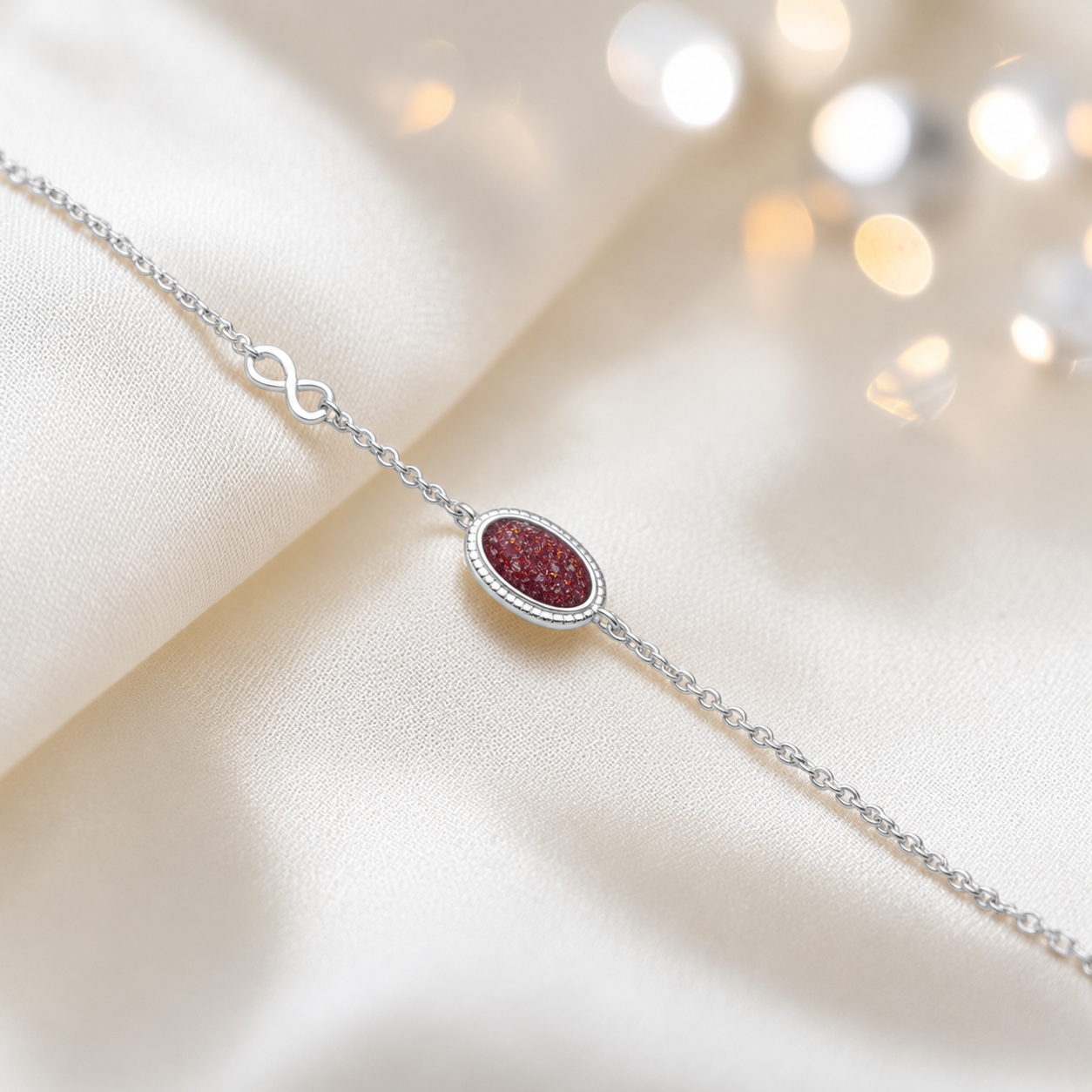 Lumen Bracelet — silver oval infinity ashes memorial bracelet in ruby red, handcrafted in Lancashire, UK - by Keepsake Memorial Jewellery