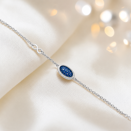 Lumen Bracelet — silver oval infinity ashes memorial bracelet in sapphire glow, handcrafted in Lancashire, UK - by Keepsake Memorial Jewellery