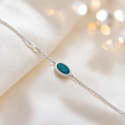 Lumen Bracelet — silver oval infinity ashes memorial bracelet in teal mist, handcrafted in Lancashire, UK - by Keepsake Memorial Jewellery