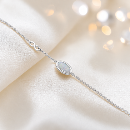 Lumen Bracelet — silver oval infinity ashes memorial bracelet in white snow, handcrafted in Lancashire, UK - by Keepsake Memorial Jewellery