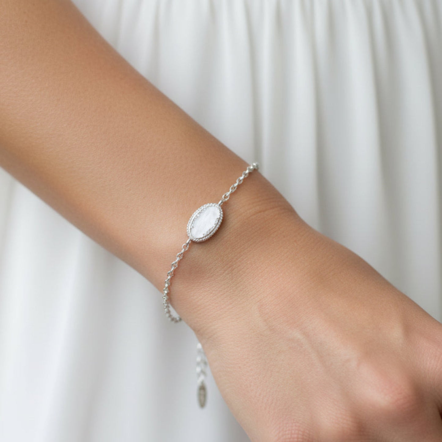 Lumen Bracelet — silver oval infinity ashes memorial bracelet worn on wrist, handcrafted in Lancashire, UK