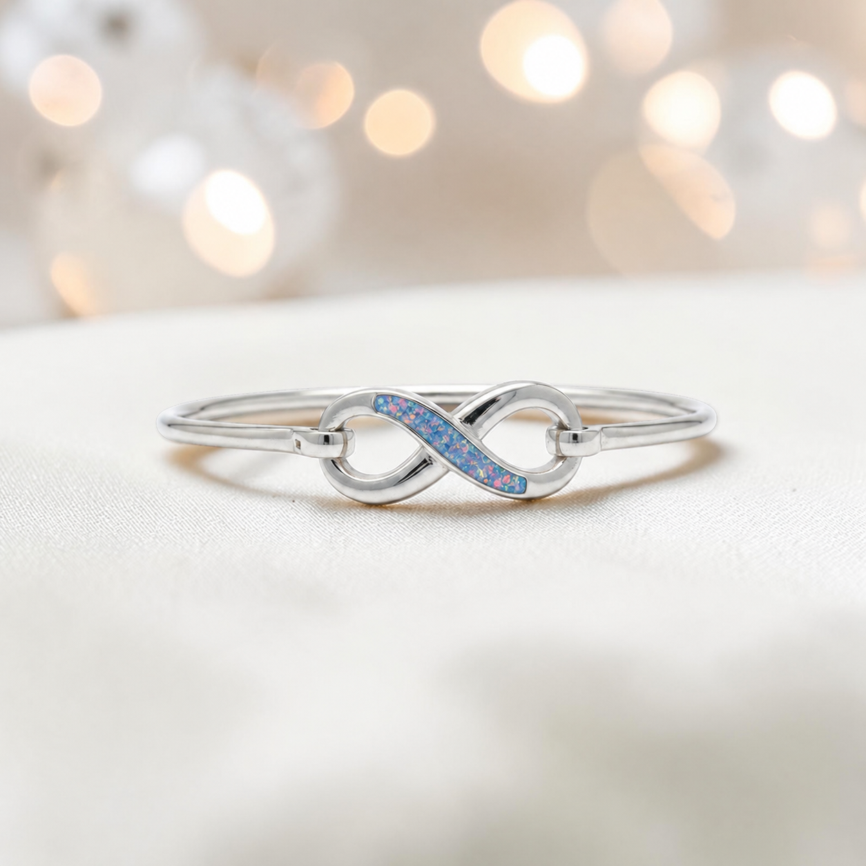 Lunara Bangle — silver infinity ashes memorial bangle in baby blue, handcrafted in Lancashire, UK - by Keepsake Memorial Jewellery