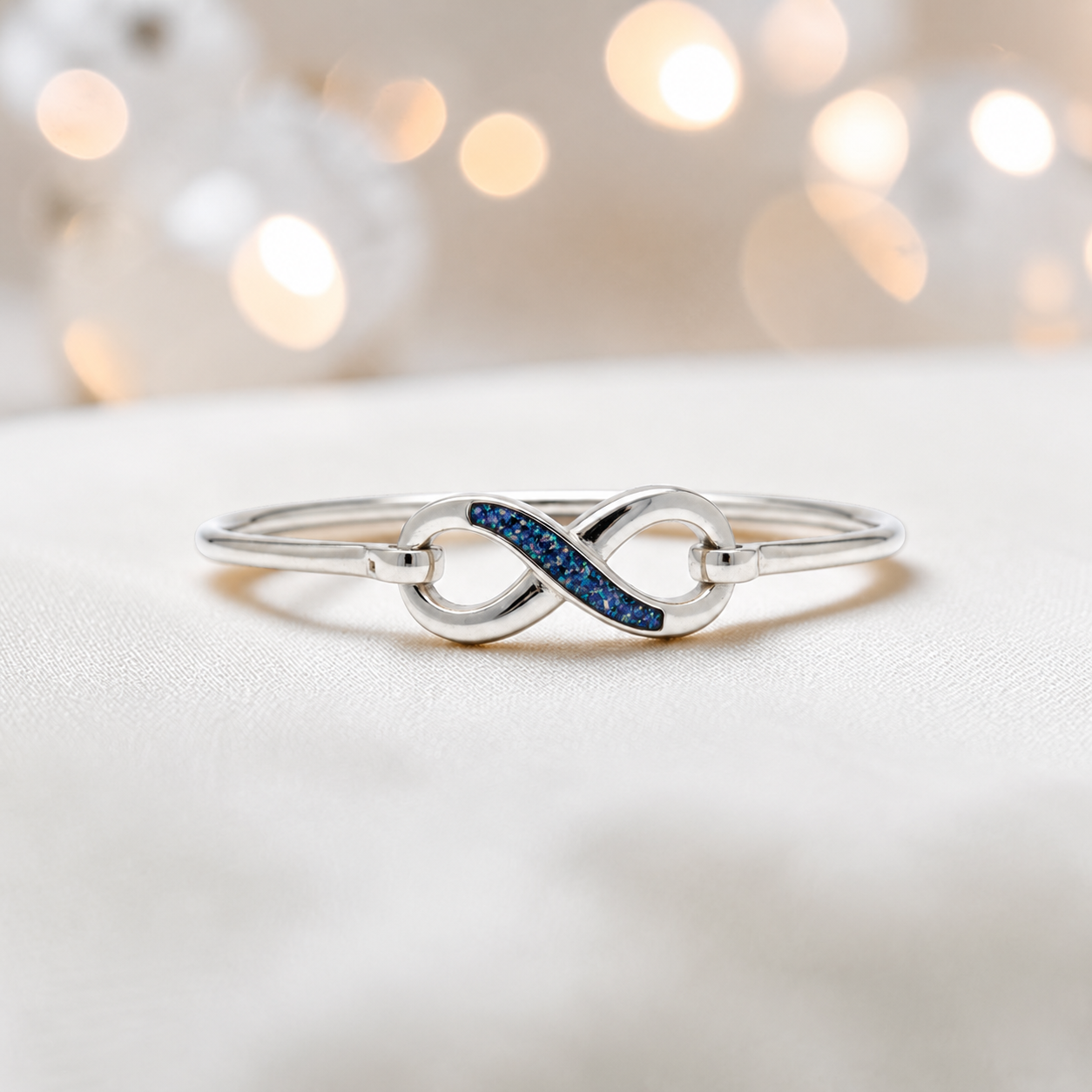 Lunara Bangle — silver infinity ashes memorial bangle in sapphire glow, handcrafted in Lancashire, UK - by Keepsake Memorial Jewellery
