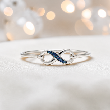Lunara Bangle — silver infinity ashes memorial bangle in sapphire glow, handcrafted in Lancashire, UK - by Keepsake Memorial Jewellery