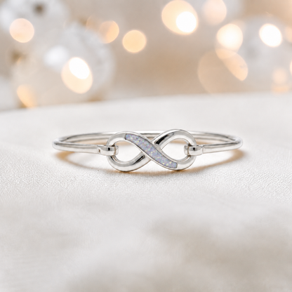 Lunara Bangle — silver infinity ashes memorial bangle in white snow, handcrafted in Lancashire, UK - by Keepsake Memorial Jewellery