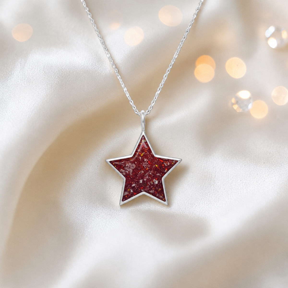 Merak sterling silver star memorial pendant in ruby red, handcrafted in Lancashire, UK