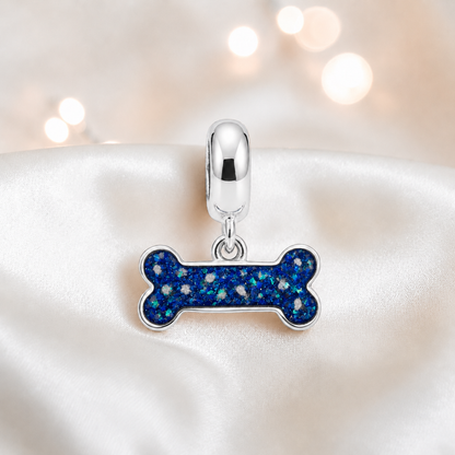 Milo silver dog bone ashes charm, in sapphire glow, handcrafted in Lancashire UK - by Keepsake Memorial Jewellery 