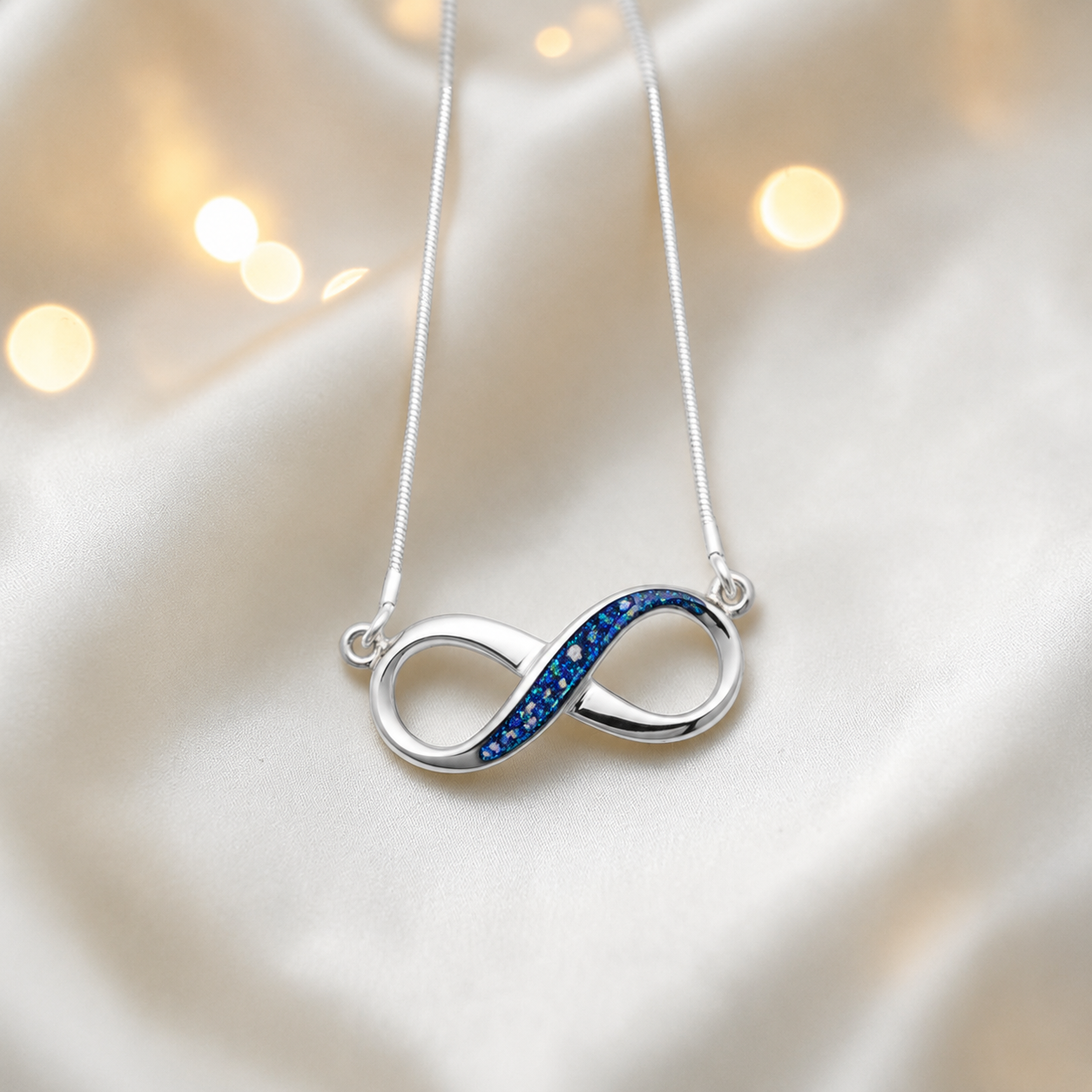 Nunki infinity memorial pendant in sapphire glow, handcrafted in Lancashire UK - by Keepsake Memorial Jewellery