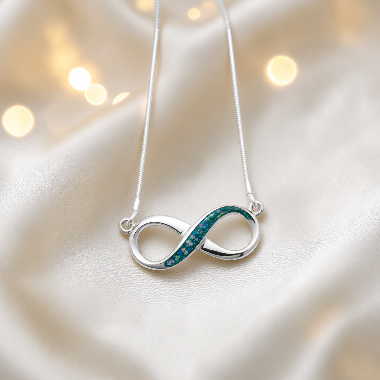 Nunki infinity memorial pendant in teal mist, handcrafted in Lancashire UK - by Keepsake Memorial Jewellery