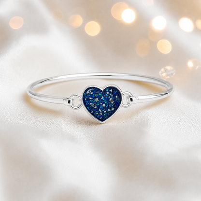Nyx Bangle — silver heart shaped ashes memorial bangle in sapphire glow, handcrafted in Lancashire, UK - by Keepsake Memorial Jewellery