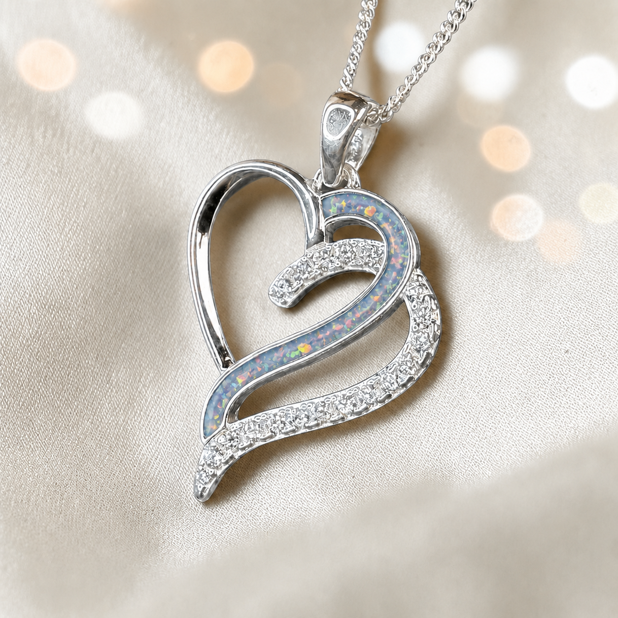 Olive Heart shaped memorial ashes pendant with CZ stones and baby blue resin. handcrafted in Lancashire, UK.