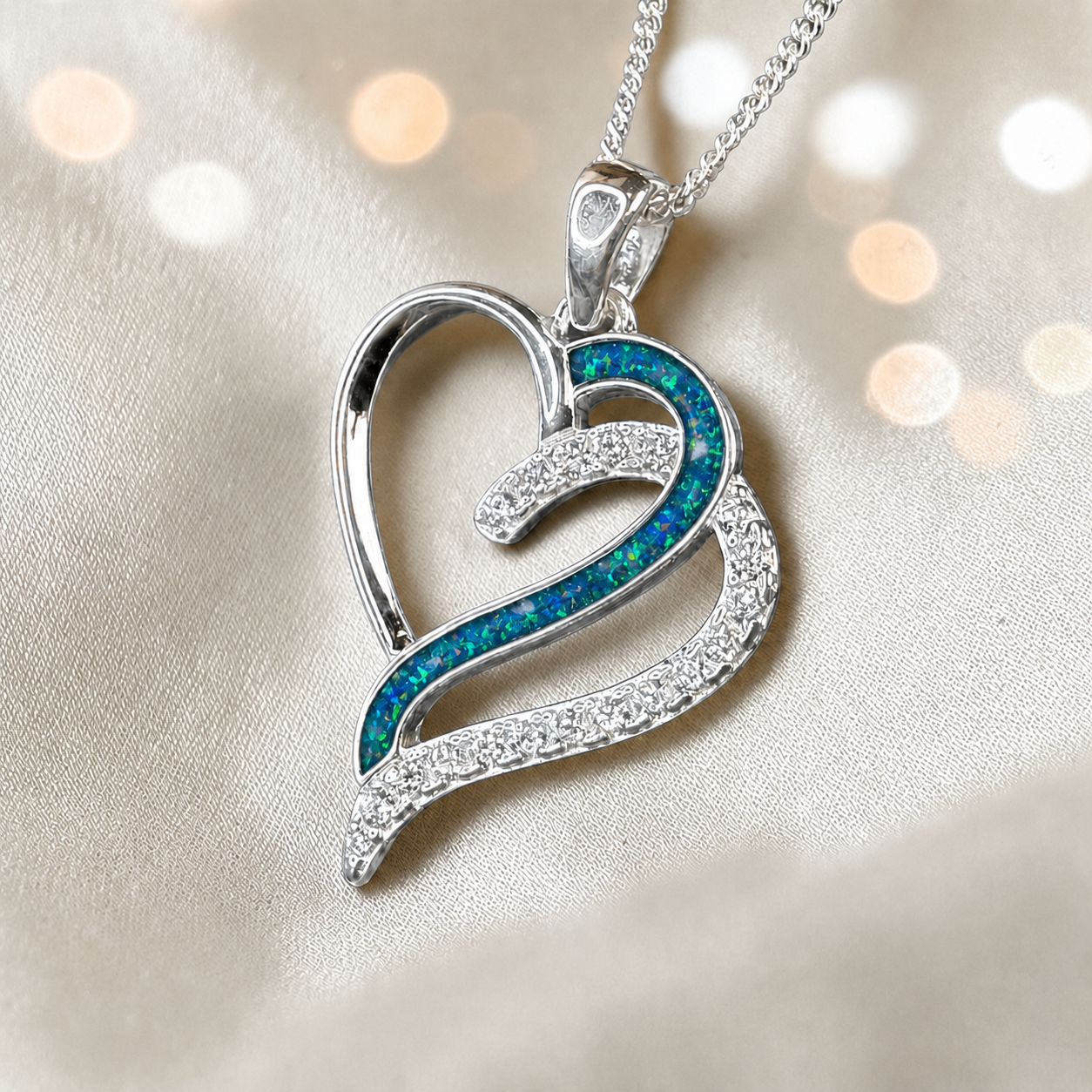 Olive Heart shaped memorial ashes pendant with CZ stones and teal mist resin. handcrafted in Lancashire, UK.