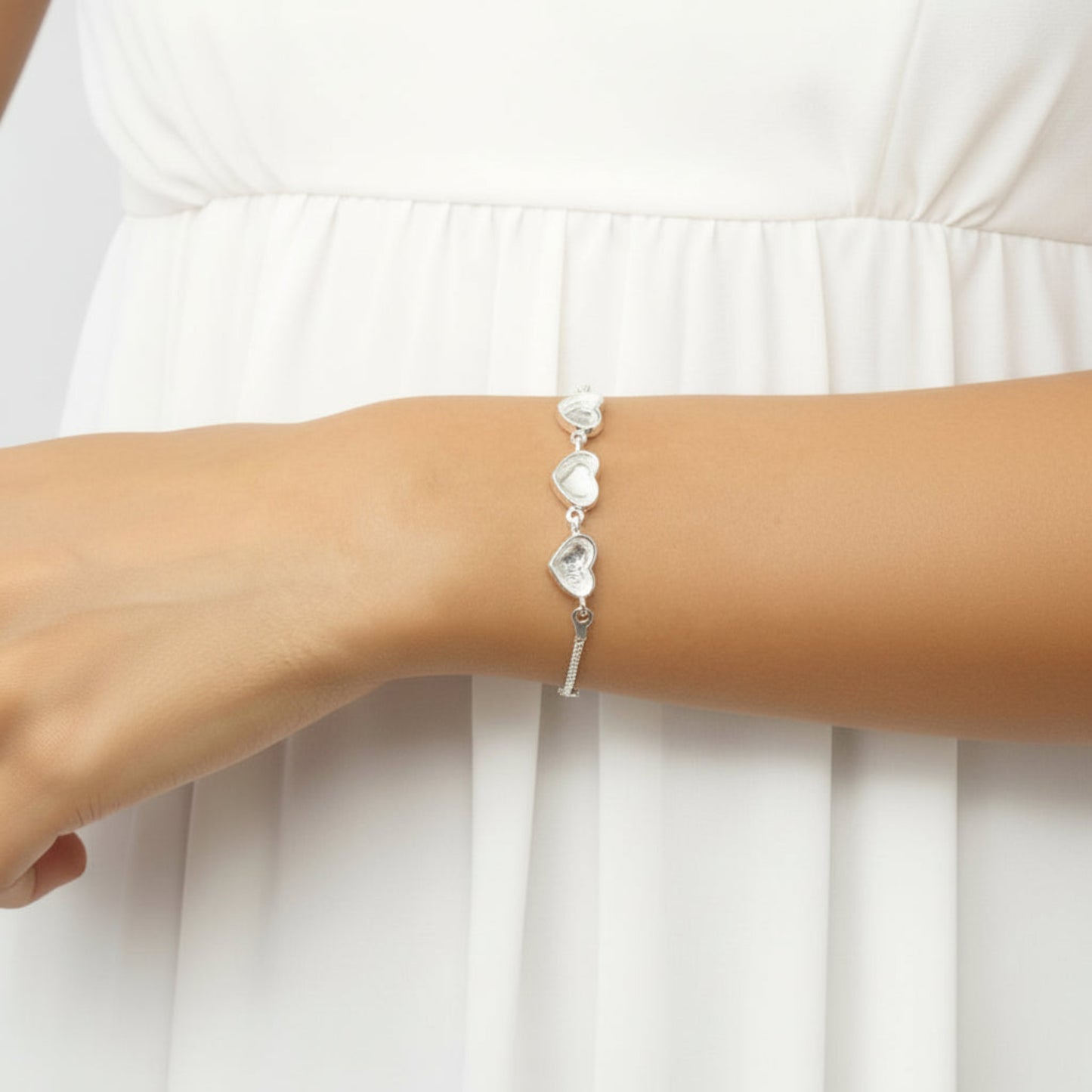 Orion Bracelet — silver three heart ashes memorial bracelet worn on wrist, handcrafted in Lancashire, UK