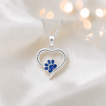 Penny Paw Pendant - heart shaped ashes memorial pendant with paw detail in sapphire glow, handcrafted in Lancashire UK - by Keepsake Memorial Jewellery