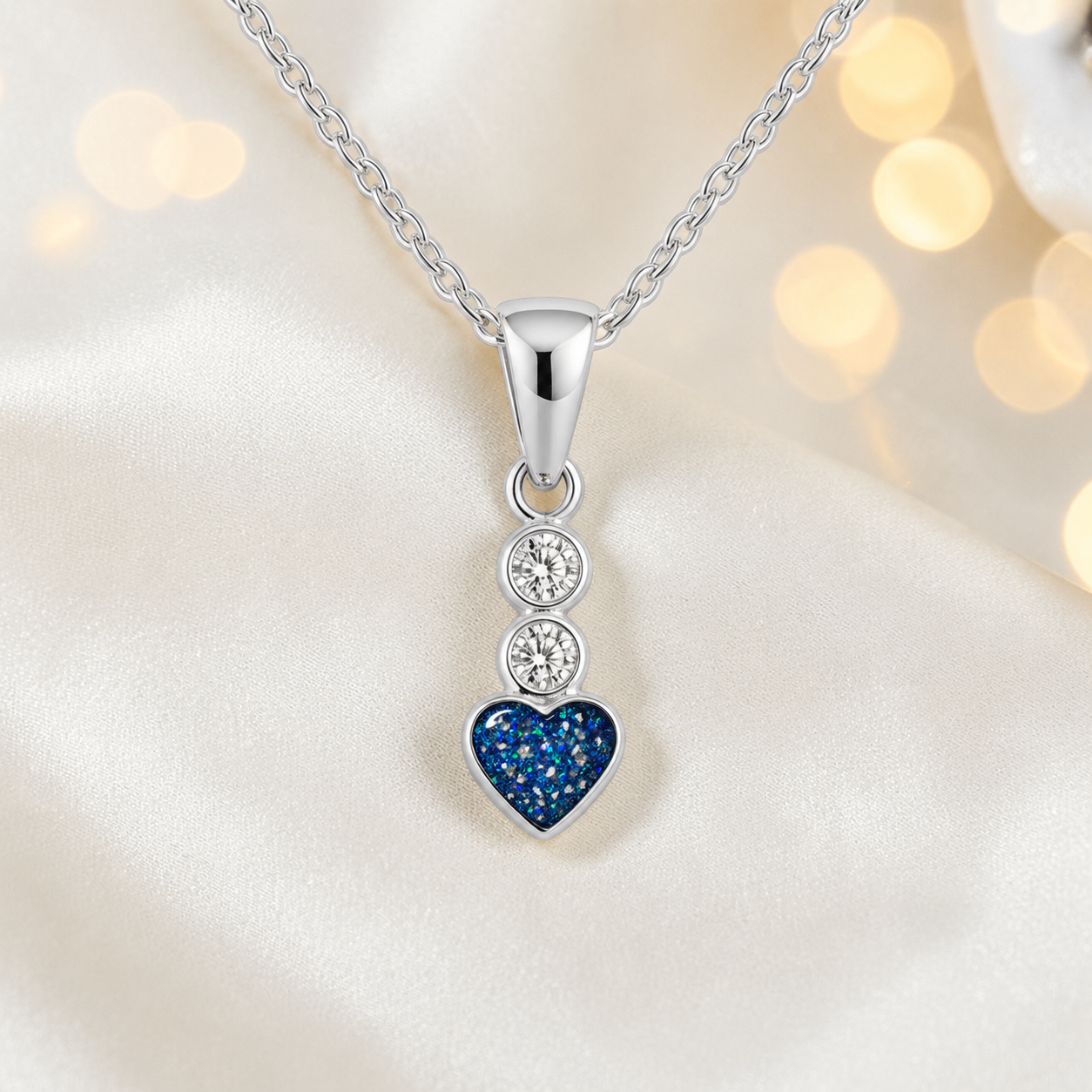 Pleione dainty heart ashes pendant in sapphire glow, handcrafted in Lancashire UK - by Keepsake Memorial Jewellery