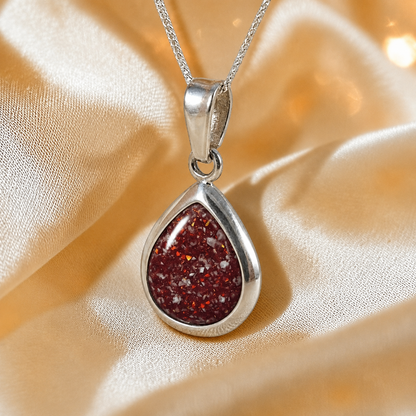 Procyon pear shaped ashes pendant in ruby red, handcrafted in Lancashire UK