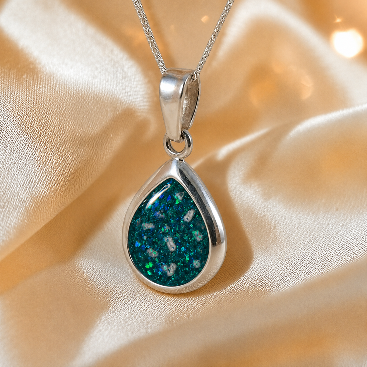 Procyon per shaped ashes pendant in teal mist, handcrafted in Lancashire UK