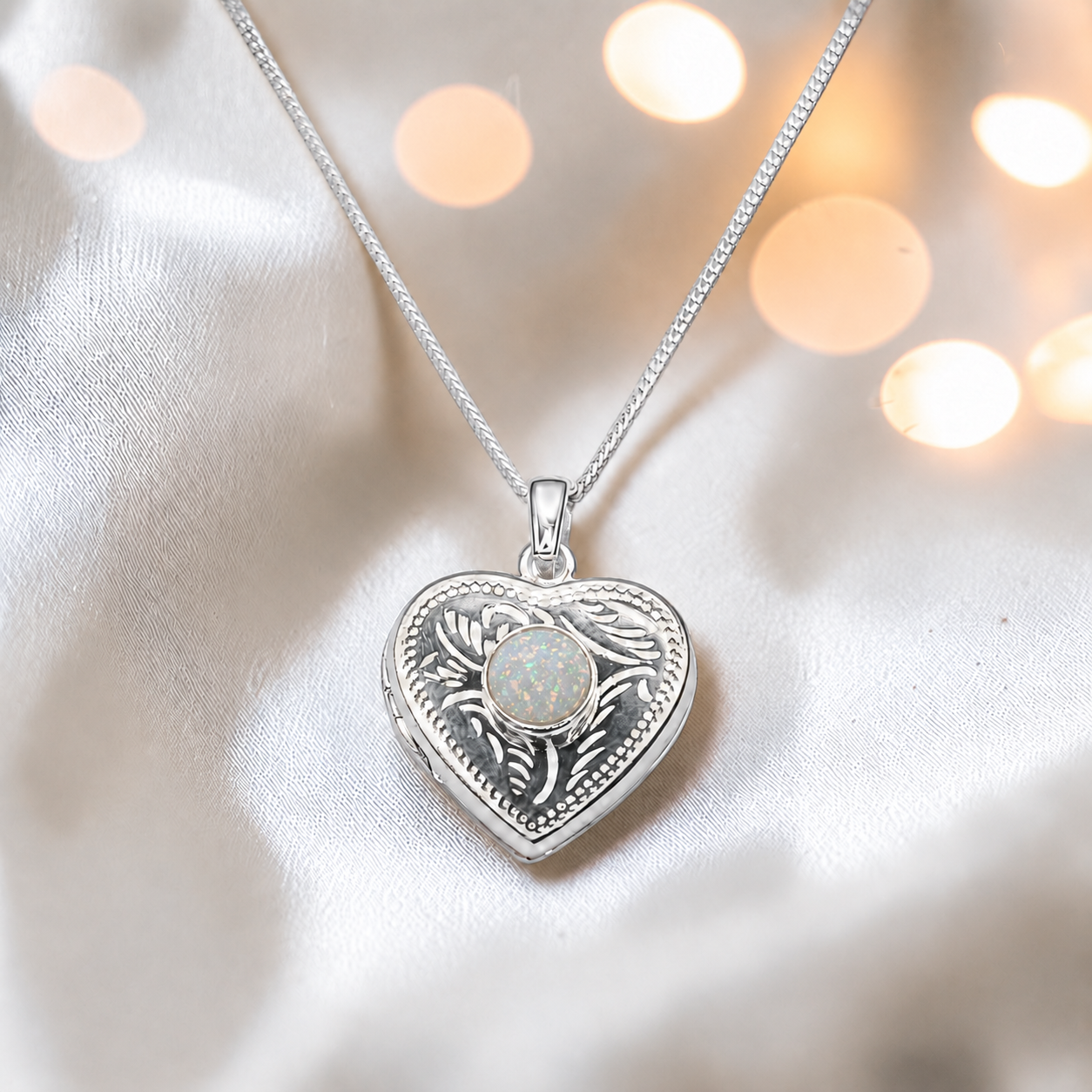 Rasal heart locket with round memorial stone in white snow, handcrafted in Lancashire UK - by Keepsake Memorial Jewellery