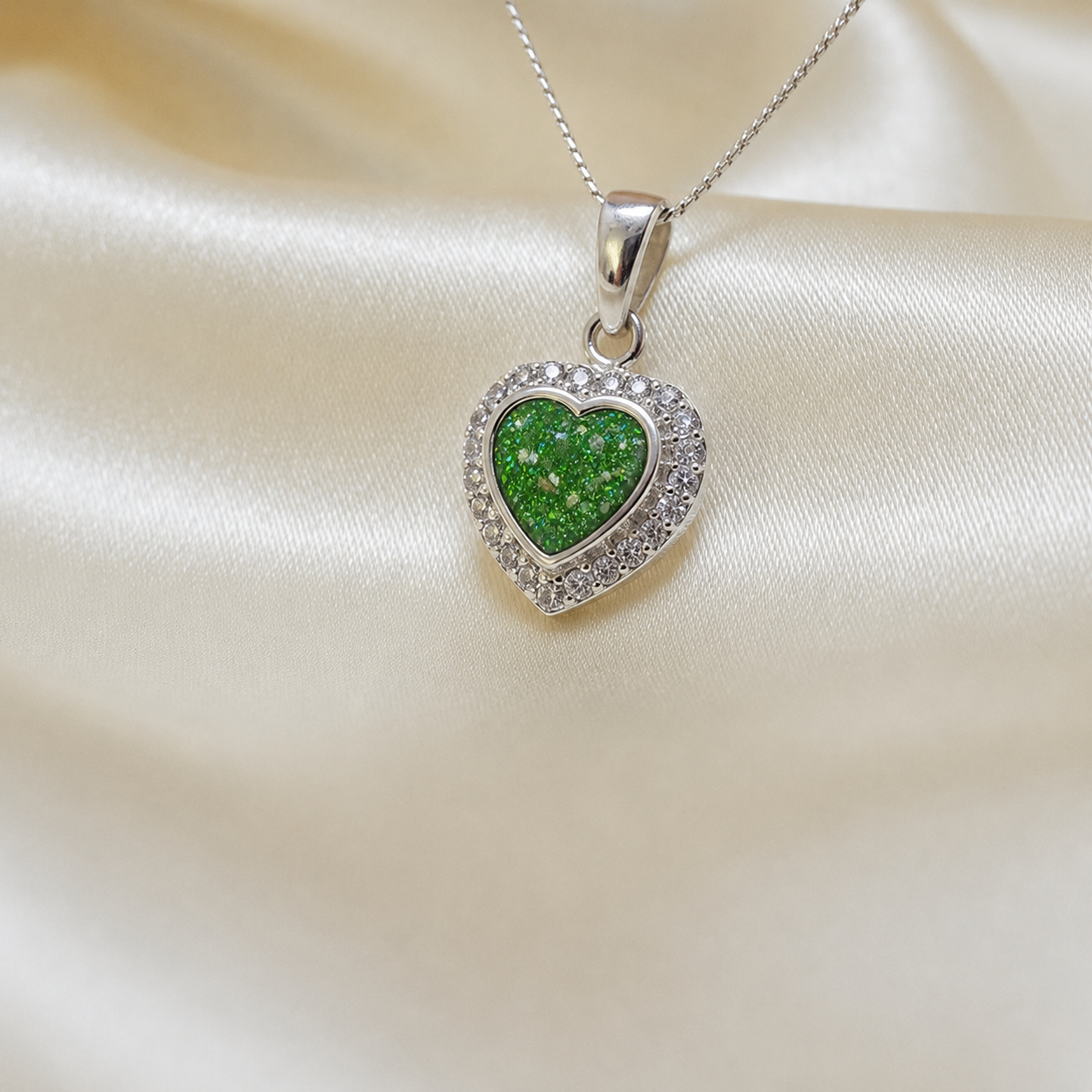 Rigel sterling silver heart ashes pendant with CZ stones, in fruit green, handcrafted in Lancashire UK 