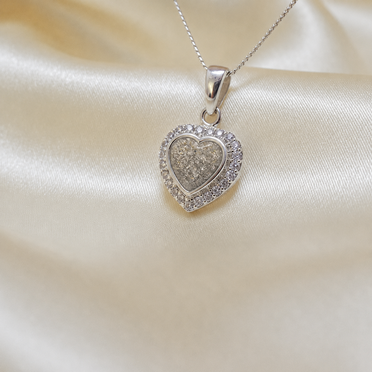 Rigel sterling silver heart ashes pendant with CZ stones, in natural ash, handcrafted in Lancashire UK 