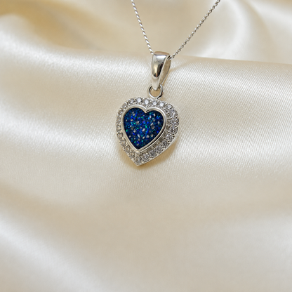 Rigel sterling silver heart ashes pendant with CZ stones, in sapphire glow, handcrafted in Lancashire UK 