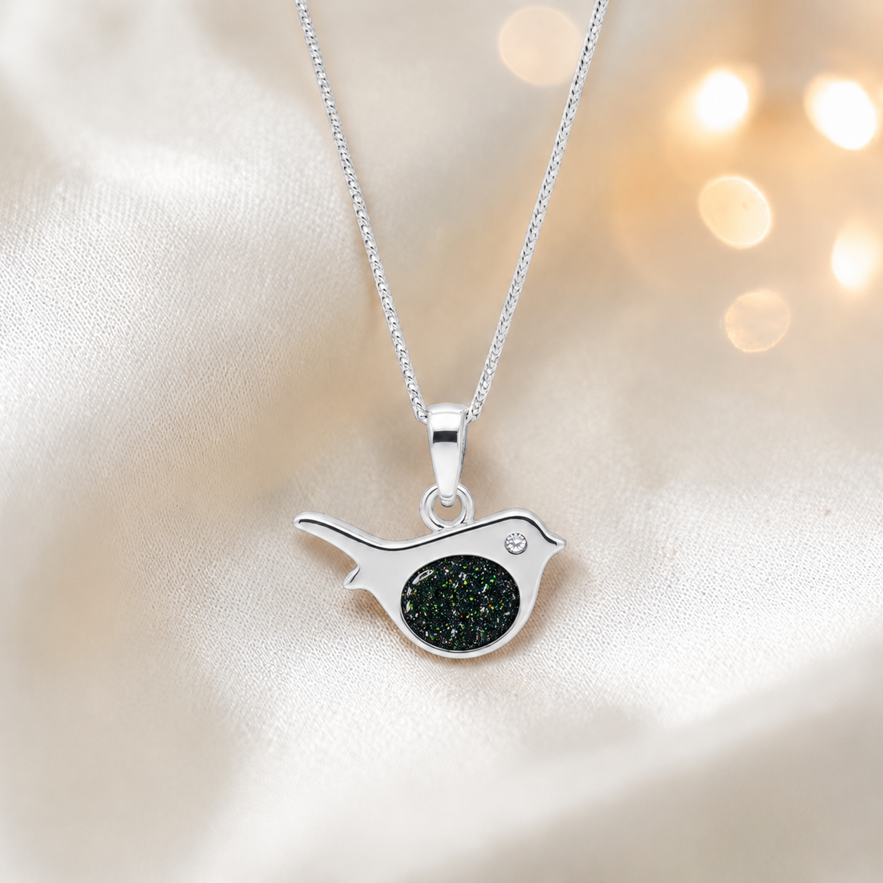 Robin bird shaped white gold memorial pendant in black flame, handcrafted in Lancashire UK - by Keepsake Memorial Jewellery