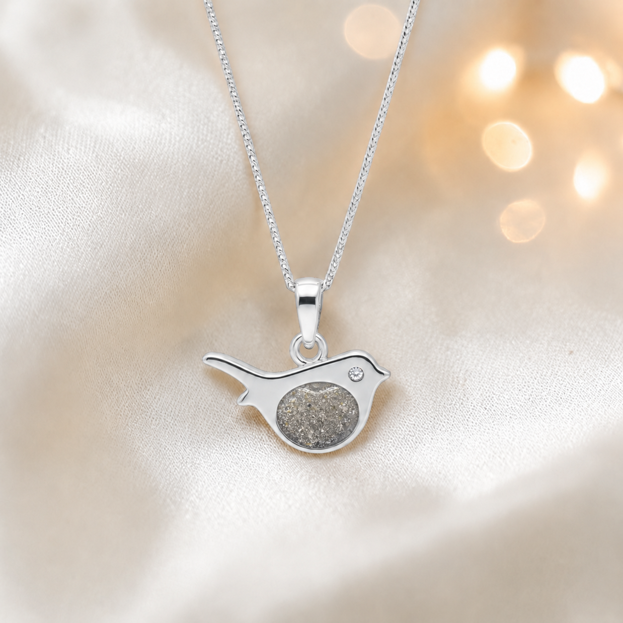 Robin bird shaped white gold memorial pendant in natural ash, handcrafted in Lancashire UK - by Keepsake Memorial Jewellery
