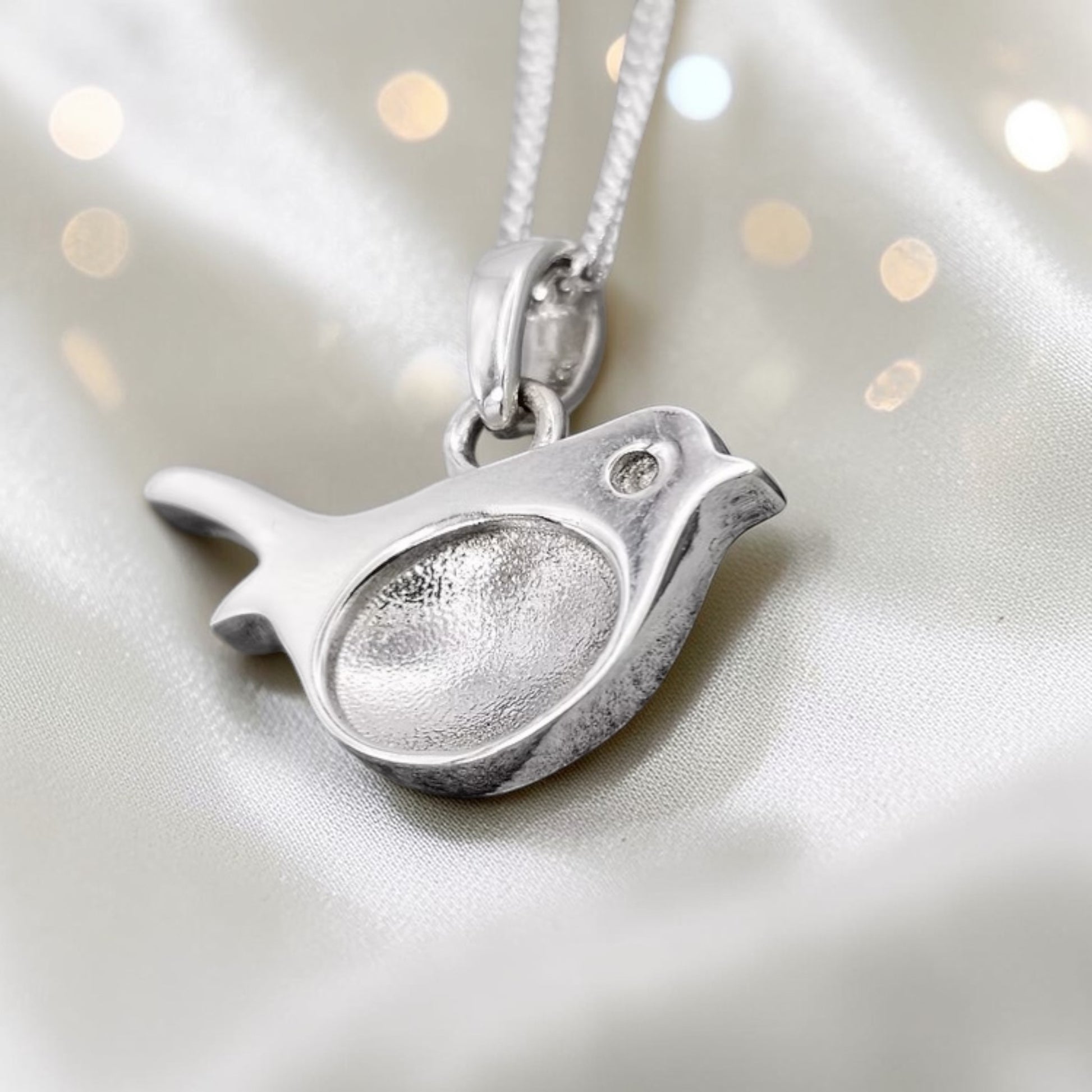 Robin sterling silver memorial pendant, close up view, handcrafted in Lancashire UK - by Keepsake Memorial Jewellery