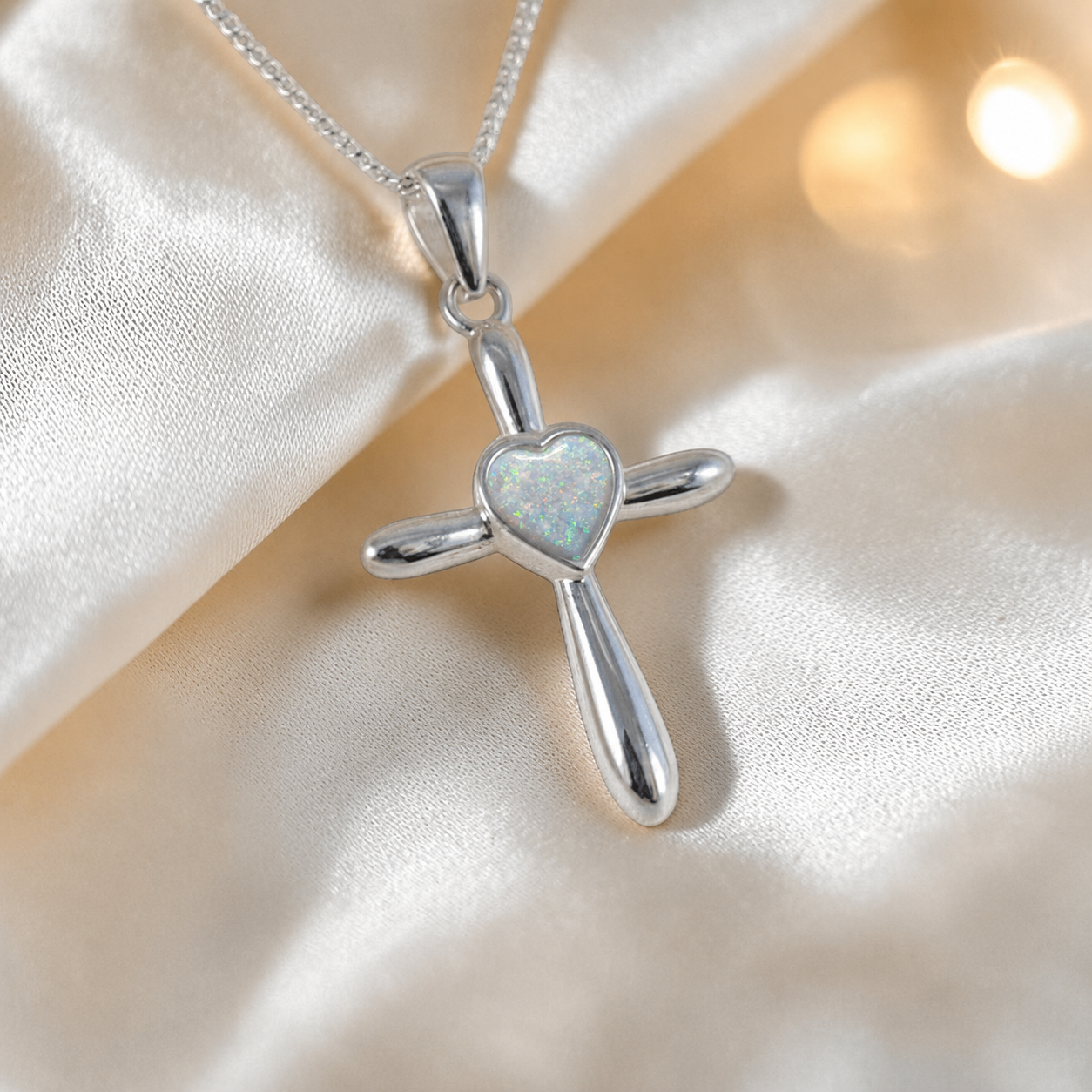 Saiph dainty sterling silver ashes cross with heart detail in white snow, handcrafted in Lancashire UK - by Keepsake Memorial Jewellery  