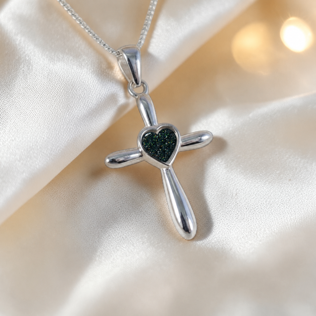 Saiph dainty sterling silver ashes cross with heart detail in black flame, handcrafted in Lancashire UK - by Keepsake Memorial Jewellery  