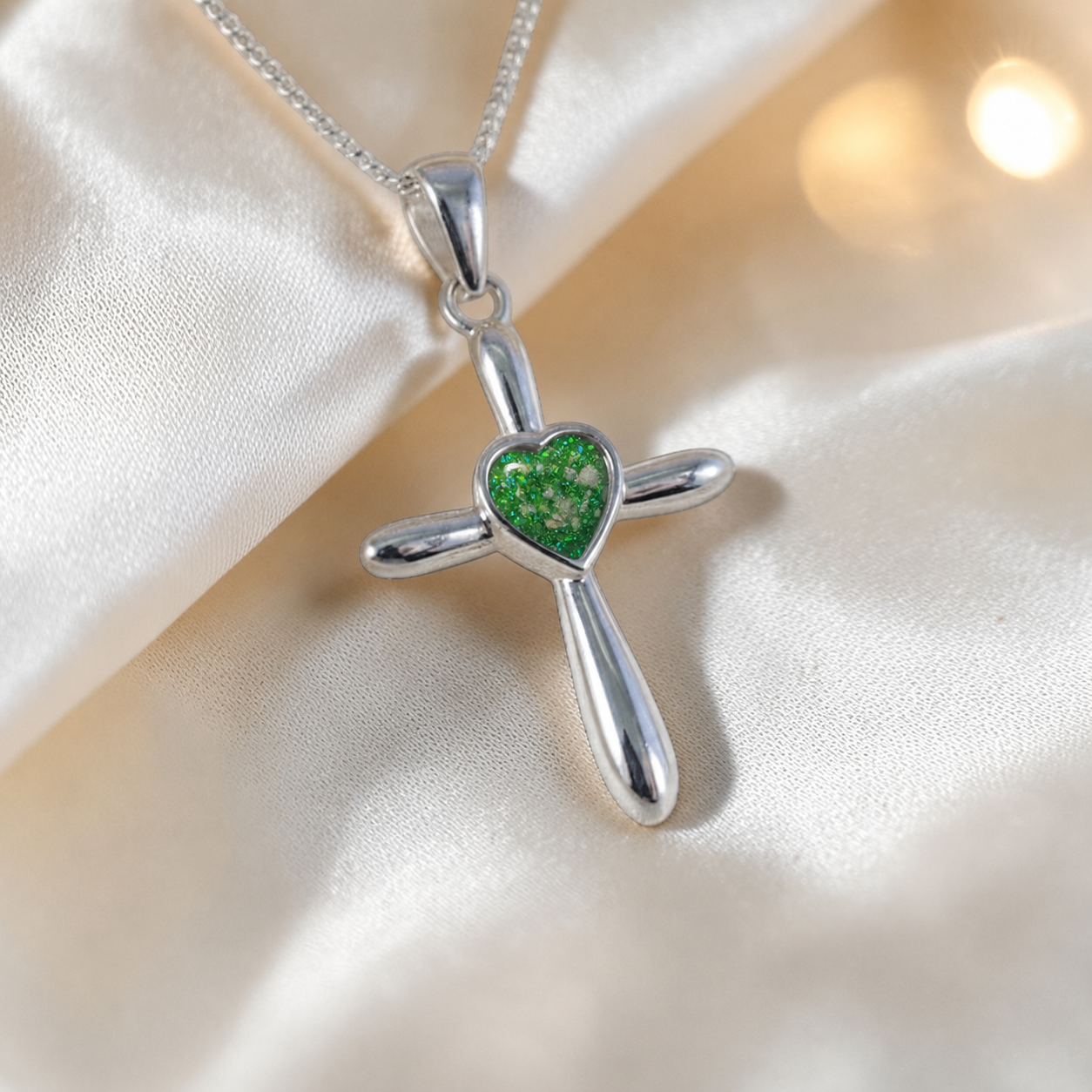 Saiph dainty sterling silver ashes cross with heart detail in fruit green, handcrafted in Lancashire UK - by Keepsake Memorial Jewellery  