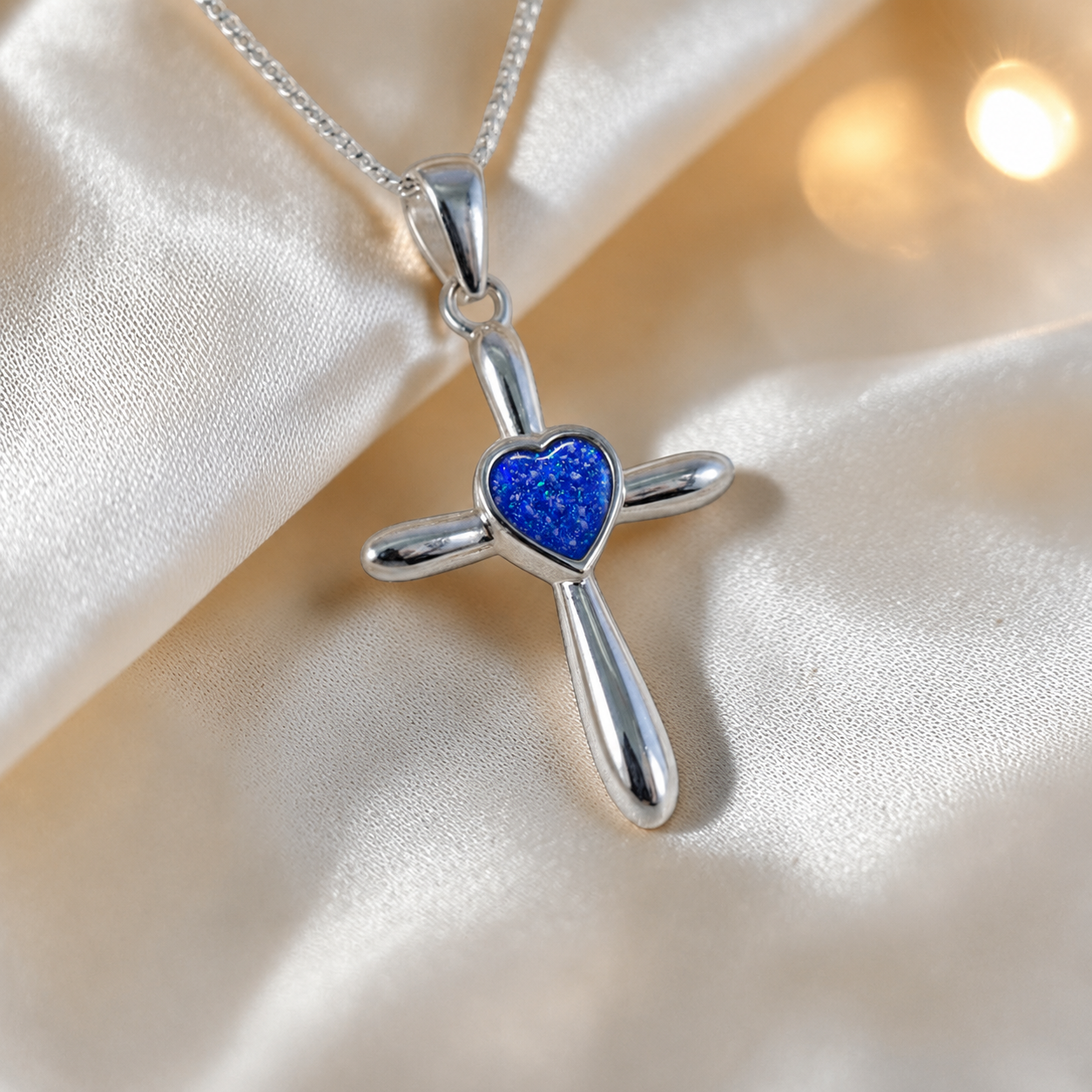 Saiph dainty sterling silver ashes cross with heart detail in royal blue, handcrafted in Lancashire UK - by Keepsake Memorial Jewellery  