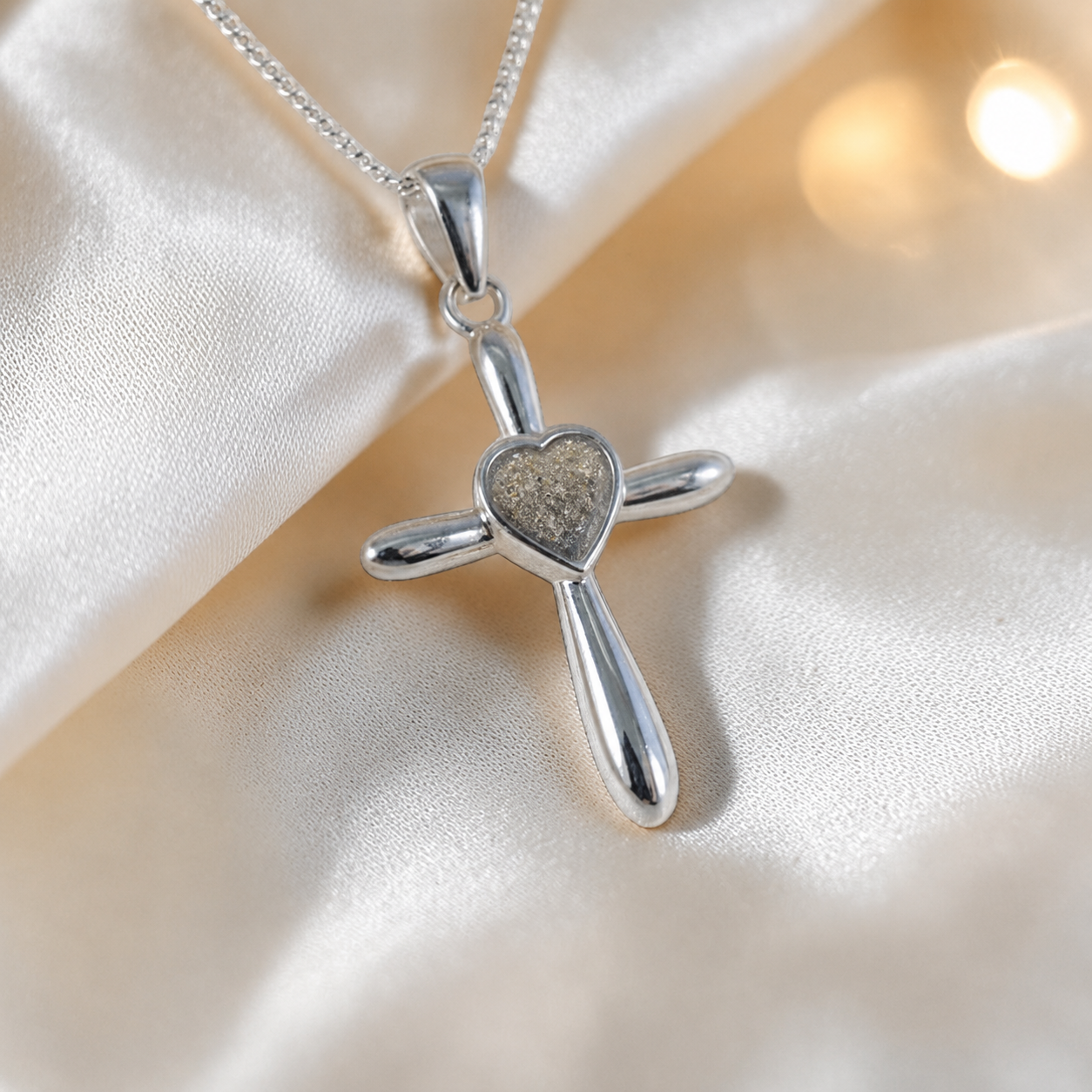 Saiph dainty sterling silver ashes cross with heart detail in natural ash, handcrafted in Lancashire UK - by Keepsake Memorial Jewellery  