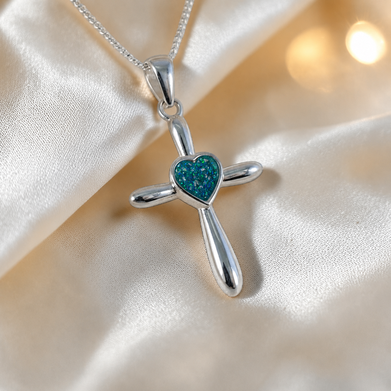 Saiph dainty sterling silver ashes cross with heart detail in teal mist, handcrafted in Lancashire UK - by Keepsake Memorial Jewellery  