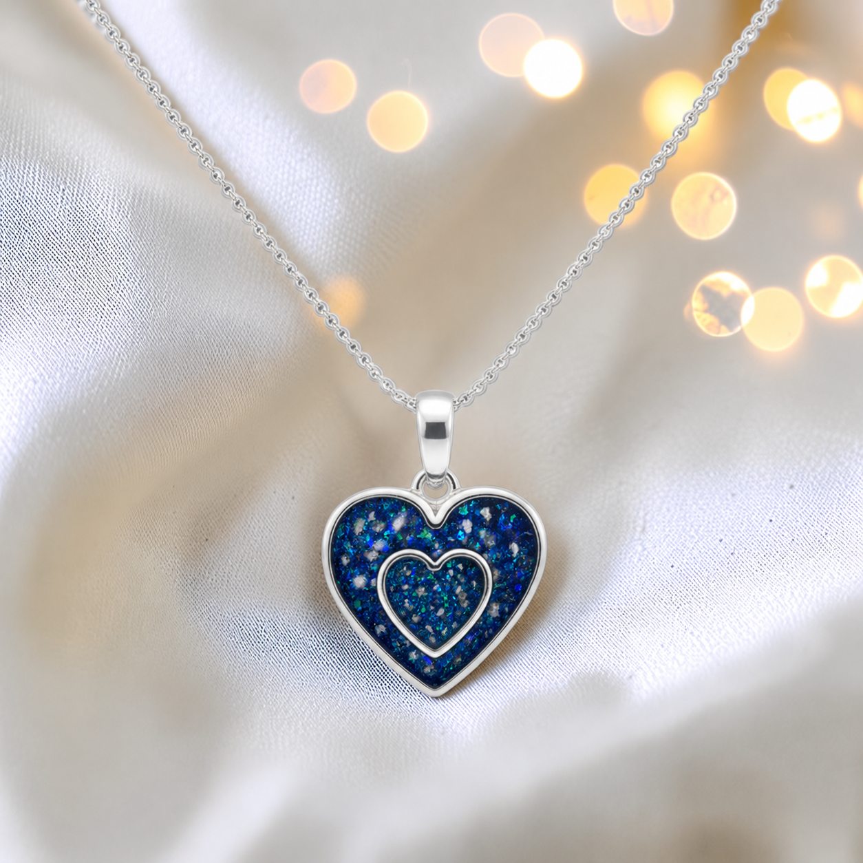 Shaula two heart memorial pendant in sapphire glow, handcrafted in Lancashire UK - by Keepsake Memorial Jewellery