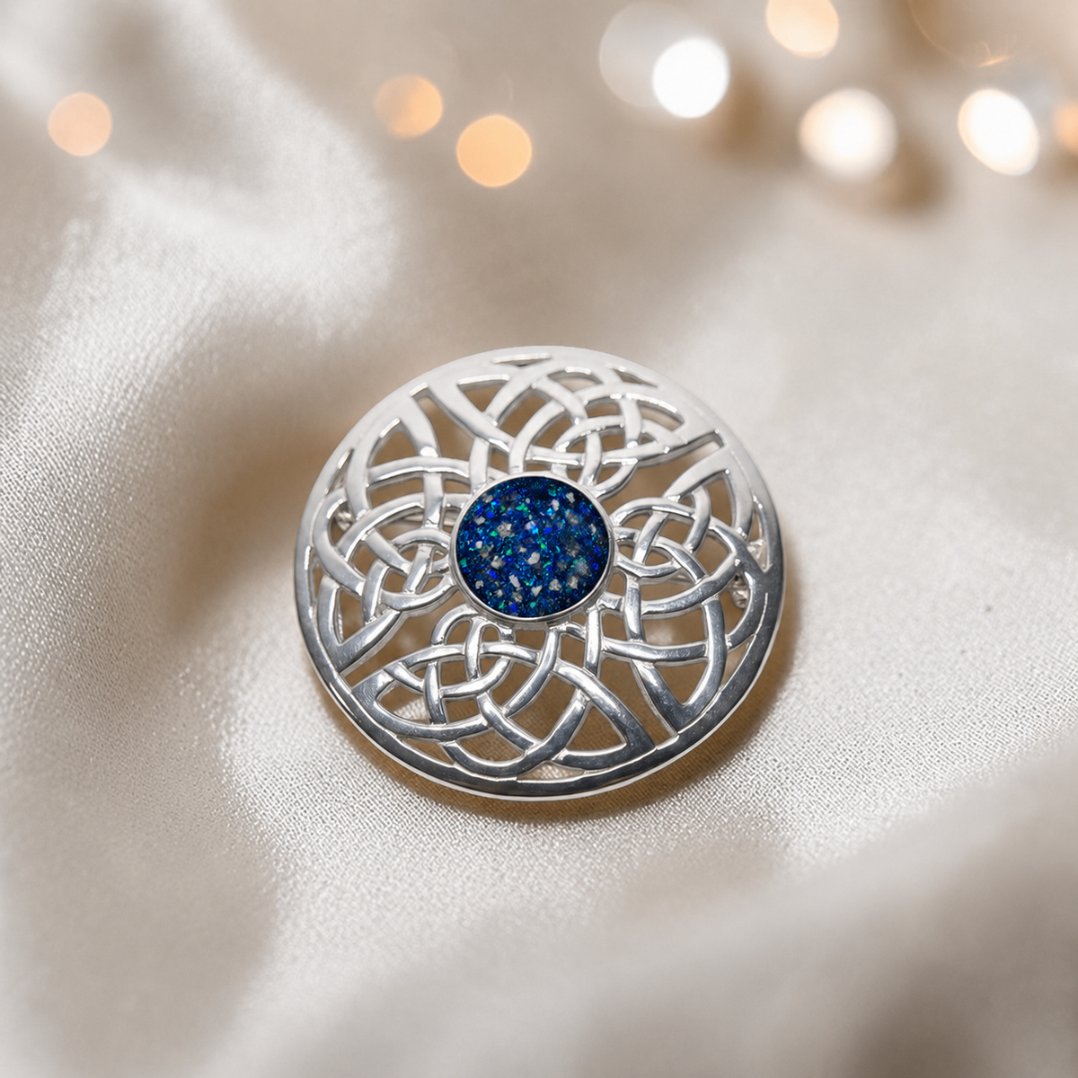 Skye brooch - sterling silver Celtic ashes memorial brooch in sapphire glow, handcrafted in Lancashire UK - by Keepsake Memorial Jewellery