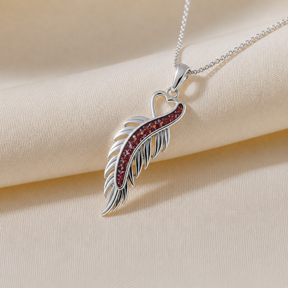 Spica feather memorial pendant in ruby red, handcrafted in Lancashire UK
