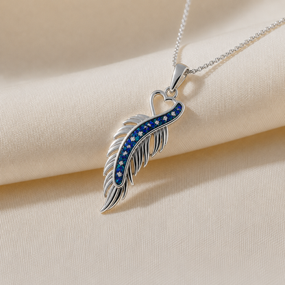 Spica feather memorial pendant in sapphire glow, handcrafted in Lancashire UK