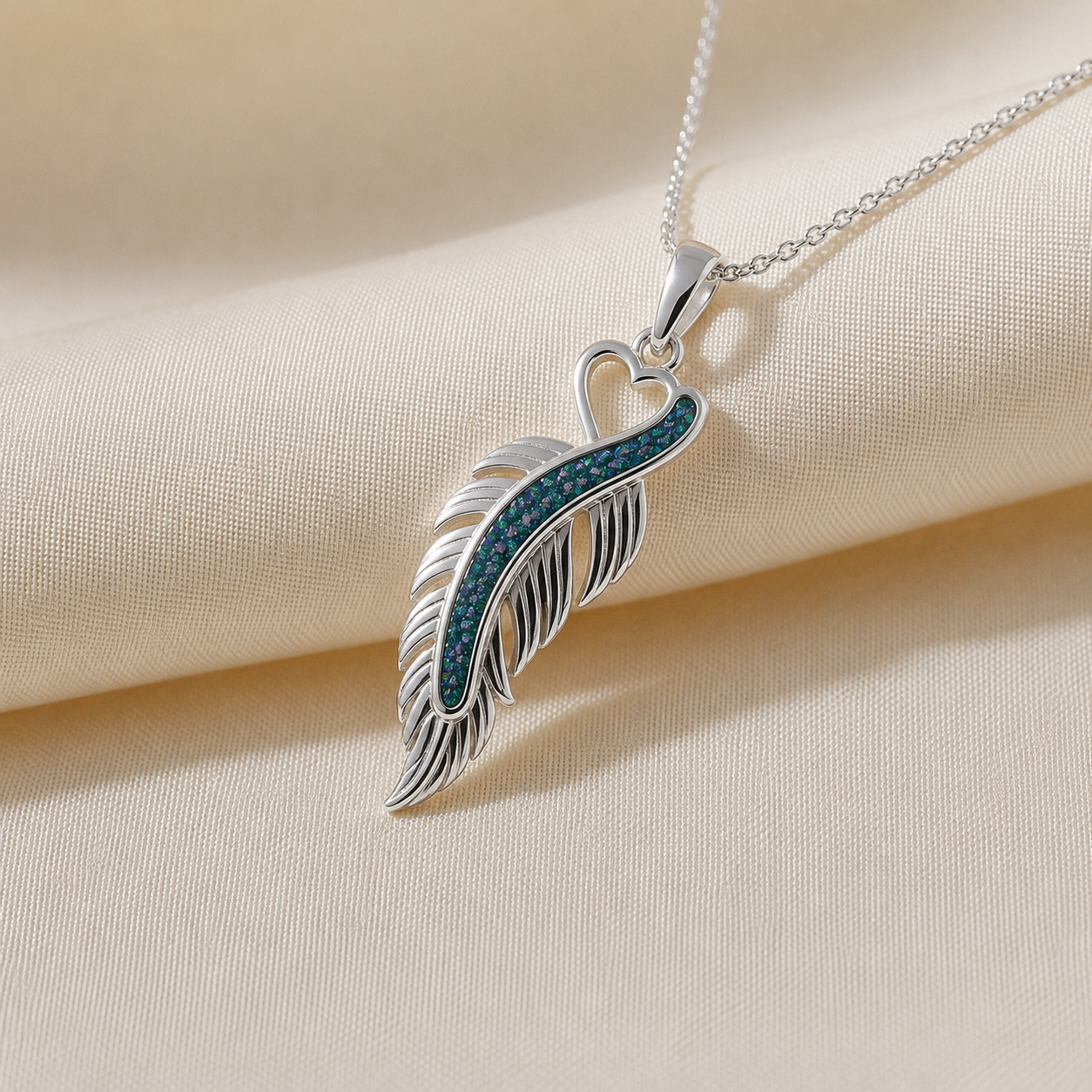 Spica feather memorial pendant in teal mist, handcrafted in Lancashire UK