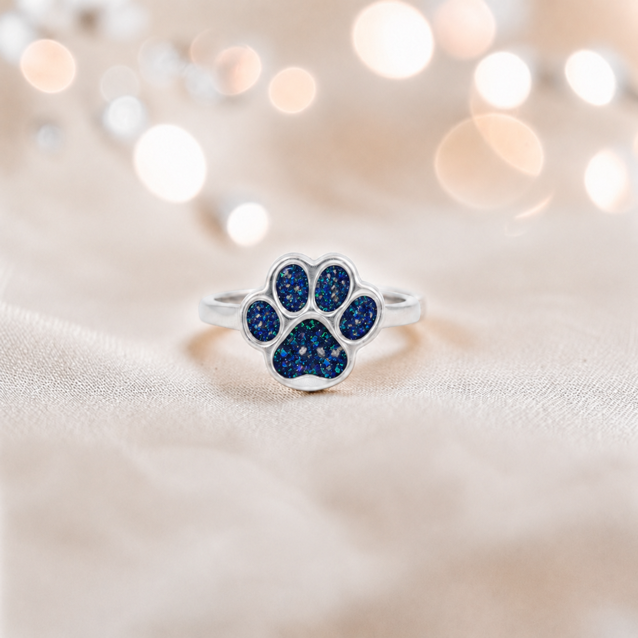 Starlight paw ashes ring in sapphire glow, handcrafted in Lancashire UK - by Keepsake Memorial Jewellery