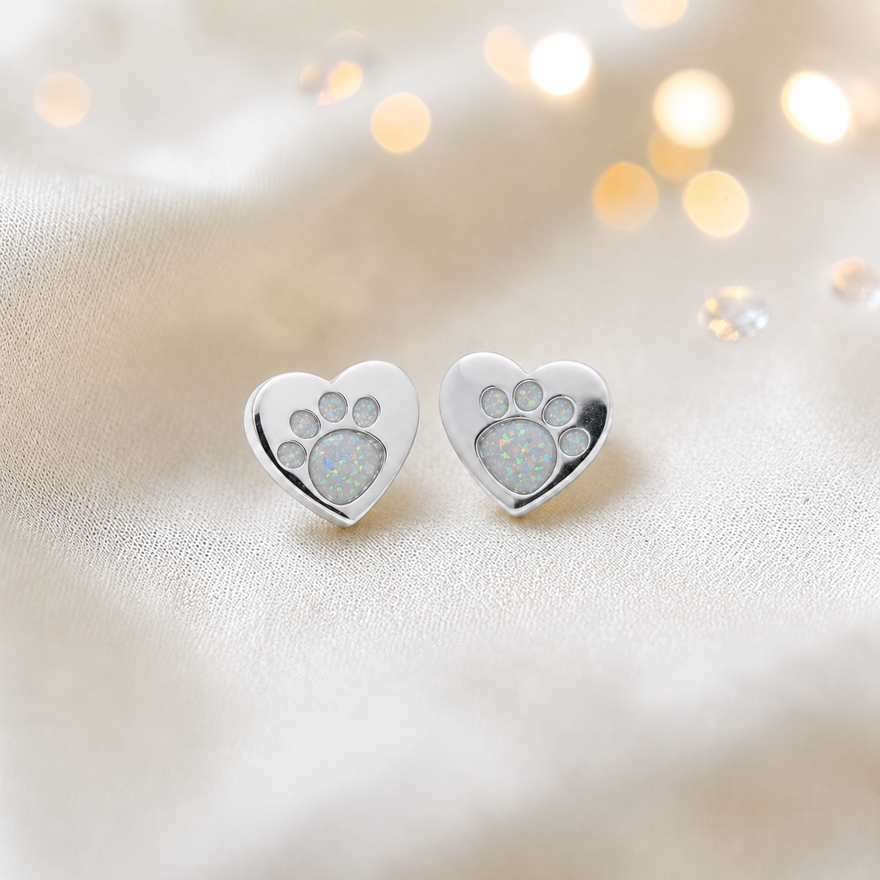 Tilly paw studs — silver heart shaped ashes memorial ear studs in white snow, handcrafted in Lancashire, UK - by Keepsake Memorial Jewellery