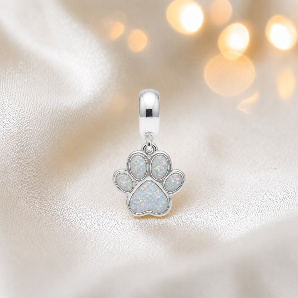 Whiskers dangle paw ashes charm, in white snow, handcrafted in Lancashire UK - by Keepsake Memorial Jewellery 