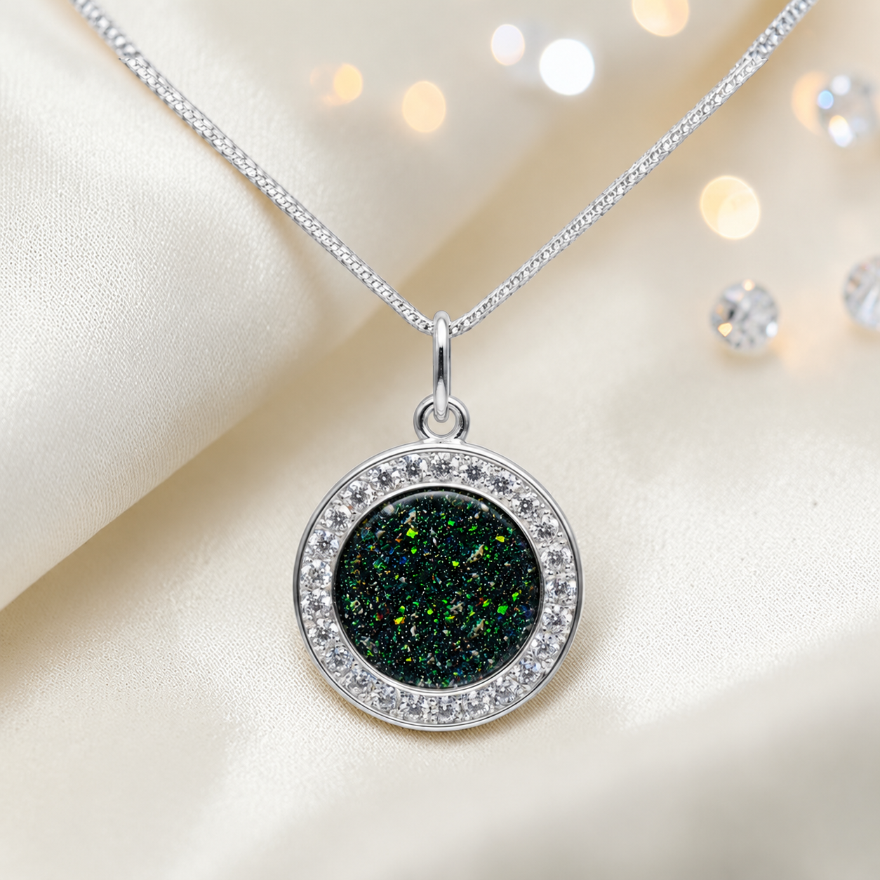 Zosma round memorial locket with CZ stones in black flame, handcrafted in Lancashire UK  by Keepsake Memorial Jewellery