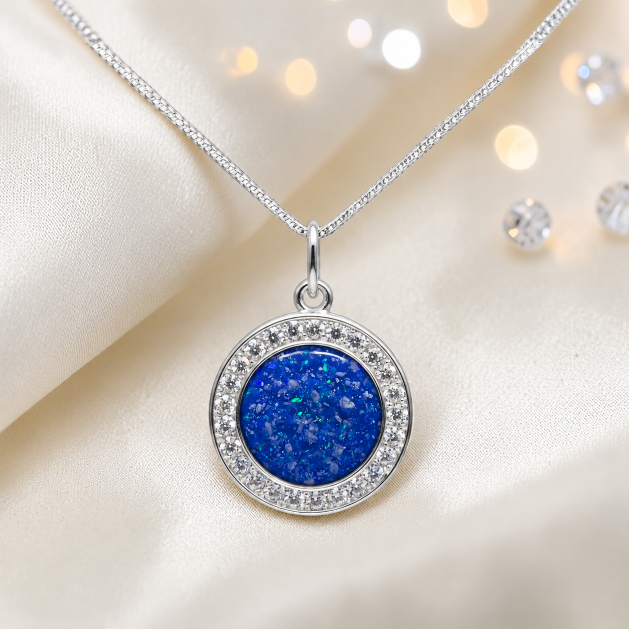 Zosma round memorial locket with CZ stones in royal blue, handcrafted in Lancashire UK  by Keepsake Memorial Jewellery